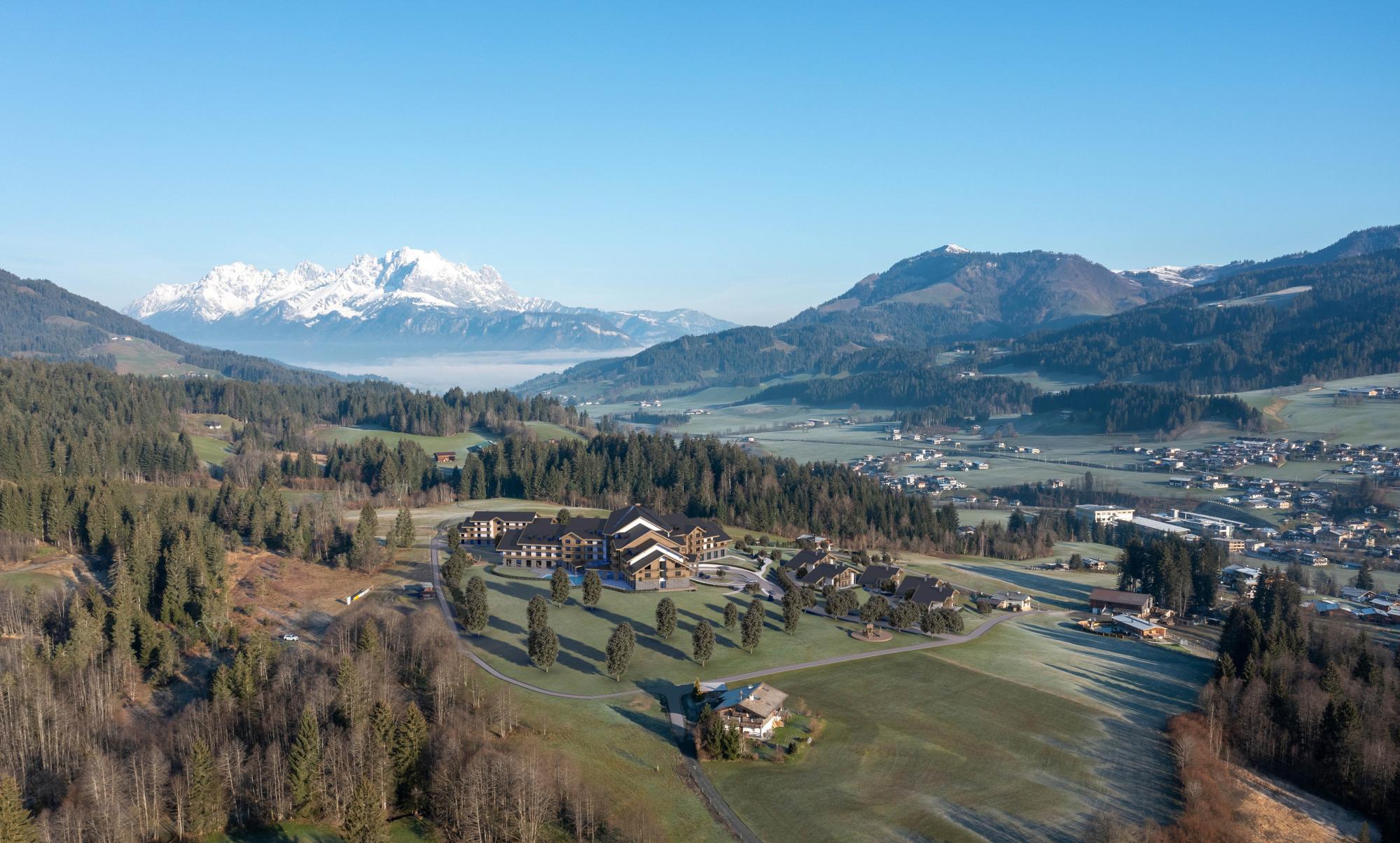 Architekturvisualisierung des geplanten Hotelkomplexes in Fieberbrunn vor den Tiroler Alpen.